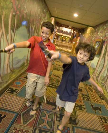 Two young boys pointing their magic wands